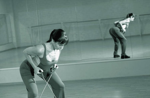 Woman using resistance bands in gym